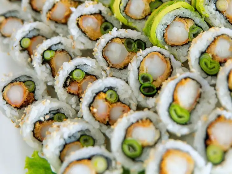 a platter of sushi, consisting of several different rolls.