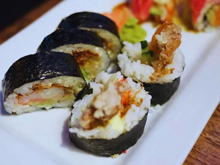 The photo displays a type of sushi known as a Spider Roll.