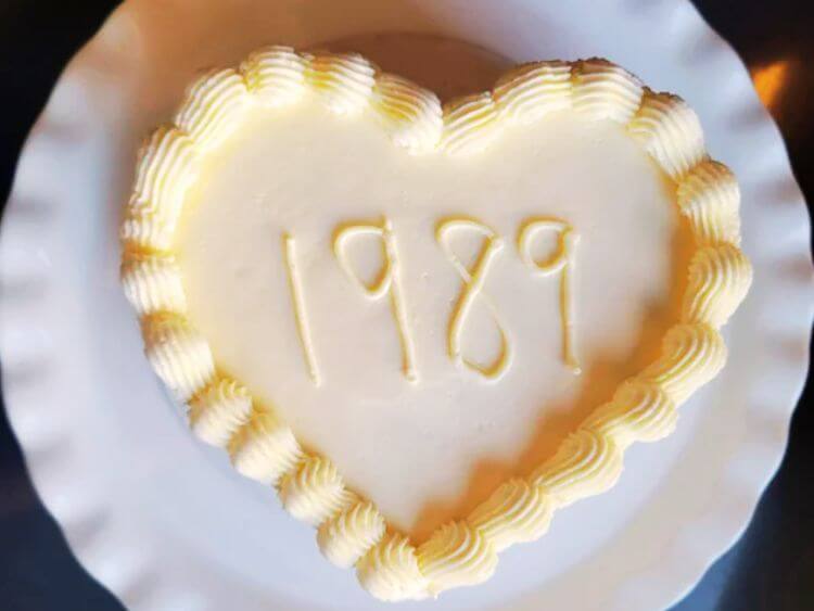 The image shows a white plate topped with a heart shaped cake.