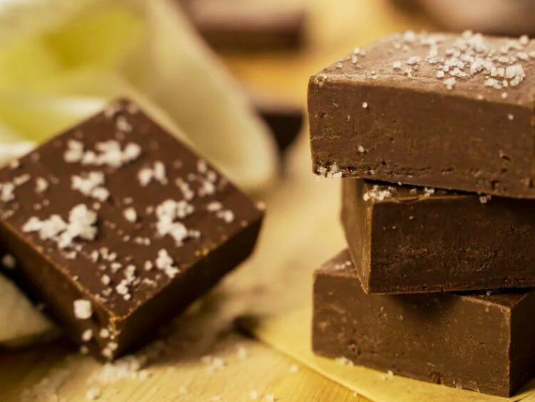 stack of four pieces of chocolate fudge with sea salt on top