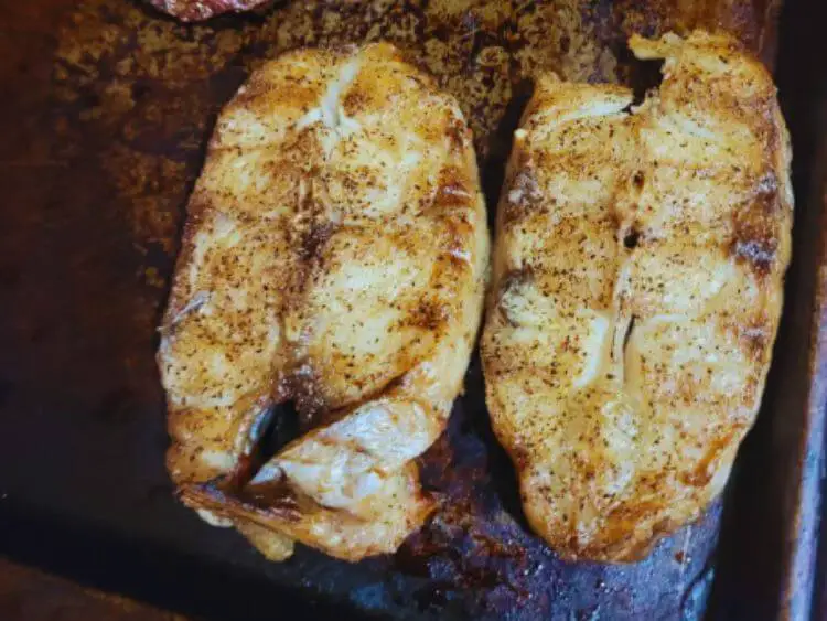 The image you sent me shows two pieces of fish sitting on top of a grill