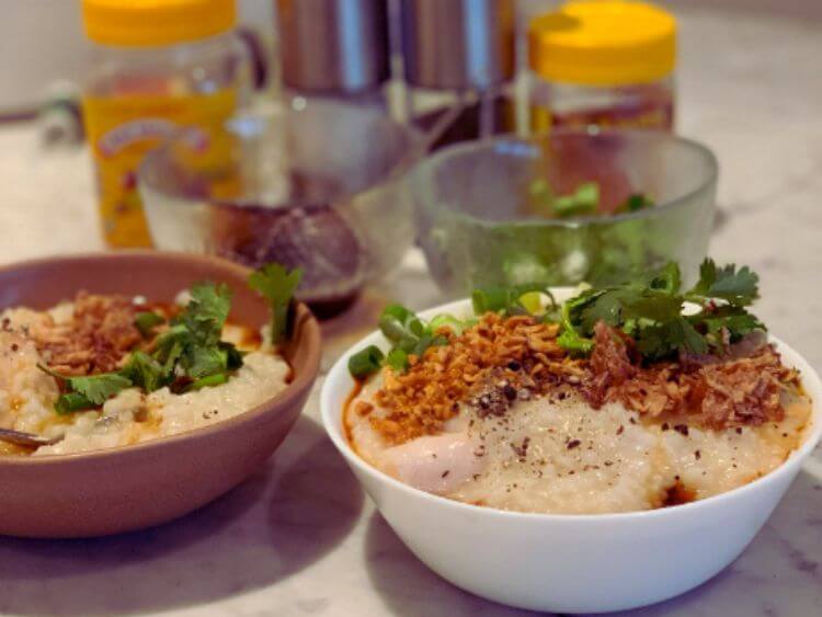 The image shows two bowls of Vietnamese fish congee,