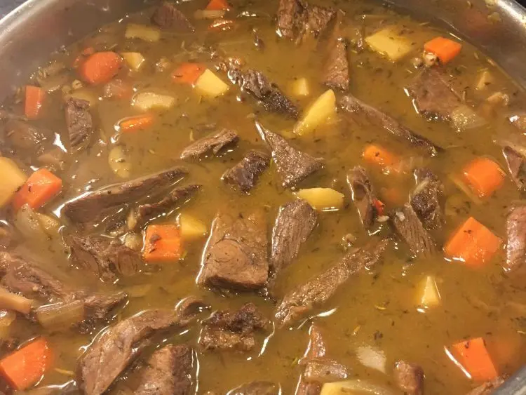 a close-up of a hearty stew or soup in progress.